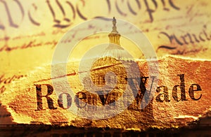 Roe v Wade newspaper headline with US Constitution and the US Capitol in Washington DC