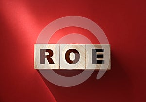 ROE on Wooden blocks and coins. Return on Equity. Business profitability success growth profitability analytics. concept