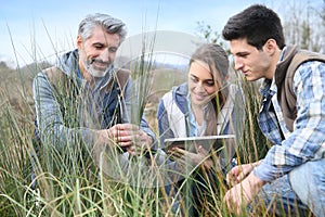 Rofessor with agronomy students outdoors photo
