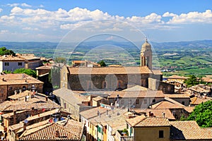 Roftops of houses and Sant`Agostino Church in Montalcino, Val d` photo