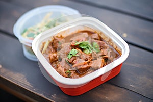 rogan josh packed in a container for takeaway