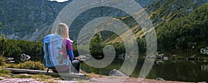 Rohacske lake in Slovakia. Western Tatras mountains, Rohace Slovakia. Woman hiker with backpack rises to the mountains. Discovery