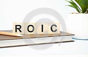 roic word written on wooden cubes with copy space