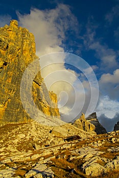 Roky cliff mountains of Dolomites yellow color at sunset