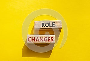 Role changes symbol. Concept words Role changes on wooden blocks. Beautiful yellow b.ckground. Business and Role changes concept.
