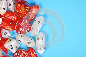 Roleplay game background with different red and white RPG dices at side of light blue background photo