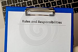 Roles and responsibilities document in the tablet at the laptop on the table.