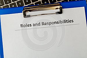 Roles and responsibilities document in the tablet at the laptop on the table.