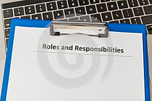 Roles and responsibilities document in the tablet at the laptop on the table.