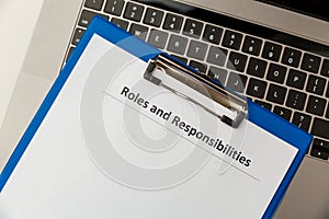 Roles and responsibilities document in the tablet at the laptop on the table.