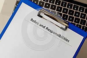 Roles and responsibilities document in the tablet at the laptop on the table.
