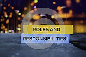 Roles and Responsibilities! on the sticky notes with bokeh background