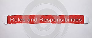 Roles and Responsibilities on torn paper