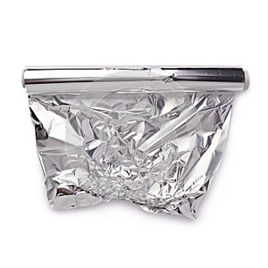 Roll of aluminium foil paper over isolated white background