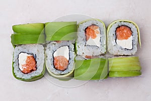 Roll avocado and salmon on top isolated