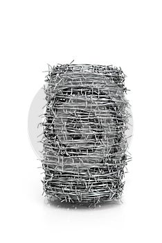 Roll of barbed wire isolated on white background, symbol of security, protection, and restriction.
