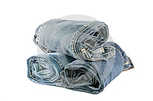 roll blue denim jeans arranged in stack