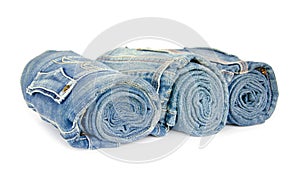 Roll blue denim jeans arranged on white background