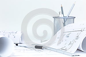 roll blueprints with technical plans, engineering tools on architect workplace deskÃÂ 