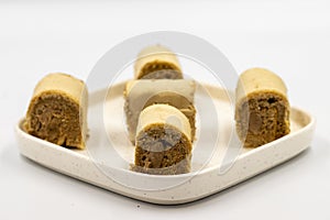 Roll cake with hazelnut and chocolate filling. roll cake on a white background.