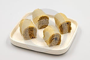 Roll cake with hazelnut and chocolate filling. roll cake on a white background.