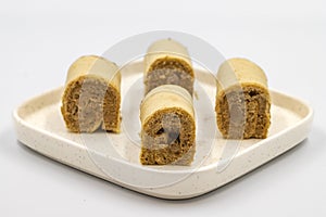 Roll cake with hazelnut and chocolate filling. roll cake on a white background.