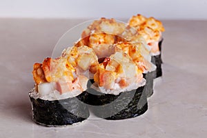 Roll cap salmon and perch, sesame, unagi on a white background isolated close-up menu for sushi oriental