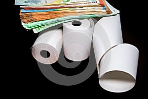 Roll of cash register tape and money isolated on table. Planning savings, spending money or business concept