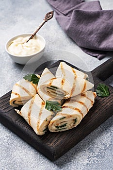 Roll with cheese and herbs. Grilled pita bread with filling. Cucumber radish salad. The concept of a healthy Breakfast