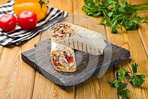roll with chicken on the Board, shaurma, shawarma, shwarm on wooden table
