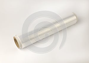 A roll of cling film. Cellophane packing tape on a white background. The concept of product packaging and storage.