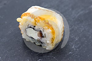 Roll closeup on black background. Traditional Japanese rice food with different additives.
