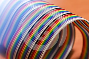 Roll of Colorful Twisted Connecting Wire Strip on Plain Surface