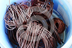 The roll of copper wire in plastic bowl