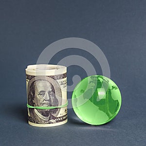 Roll of dollars and green planet earth globe. International money transfers, attraction of investments. Global financial system.