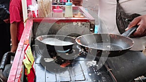 Roll the dough yeast. Male Hands of chef making cake close-up. Asian street food, cake made out of sweet dough rolled