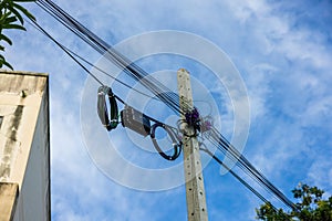 A roll of fiber-optic cables is suspended from a pole. High-speed internet communication optical fiber cable On a blue sky