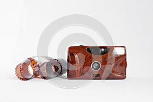 a roll film and a film retro camera of red color on a white isolated background. analog photography concept