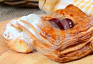 Roll from flaky pastry with cherry photo