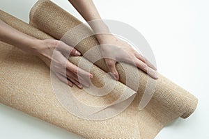 A roll of flax of light color in the hands