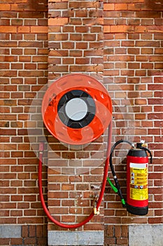 Roll of flexible tube and a fire extinguisher photo