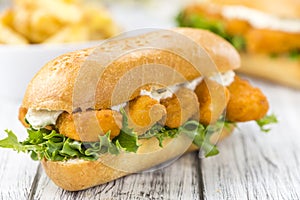 Roll with fried Fish Sticks (close-up shot)