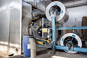 Roll of galvanized steel or metal on machine in industrial workshop on rolling mill, manufacturing metalwork factory