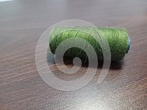  roll of green sewing thread on the table