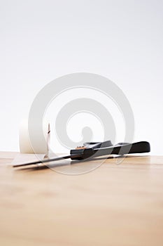 Roll of Medical Sticking Plaster and Pair of Cutting Scissors on a Wooden surface