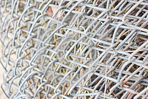 Roll of metal mesh, fence. Textured metal mesh in close-up.