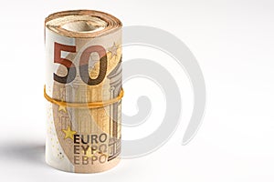 Roll of money. Roll of 50 euro banknotes. Euro banknotes rolled up on a gray background. The concept of financial