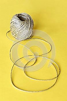 Roll of natural sisal twine on yellow