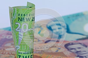 A roll of New Zealand dollars with copy space.