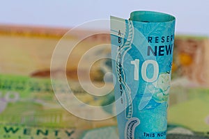 A roll of New Zealand dollars with copy space.